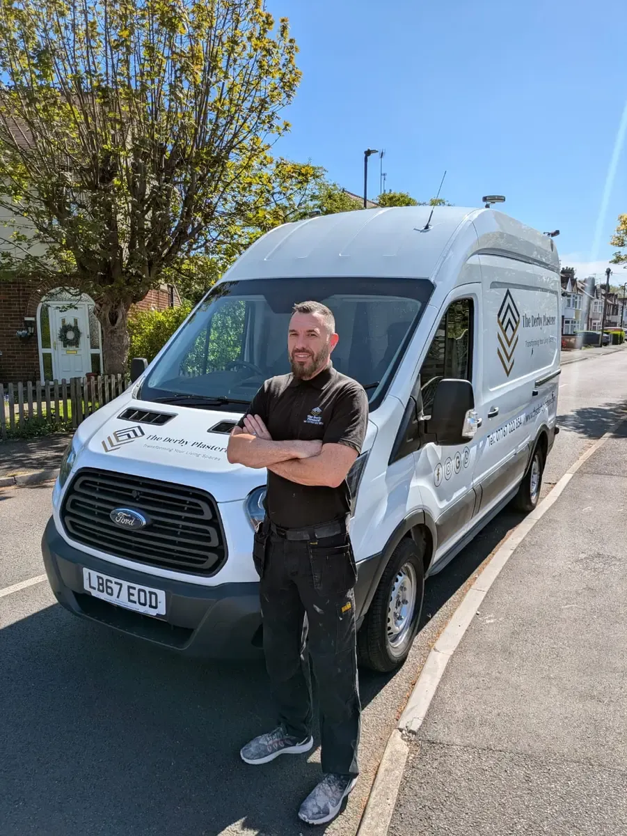 The Derby Plasterer standing beside the branded company van