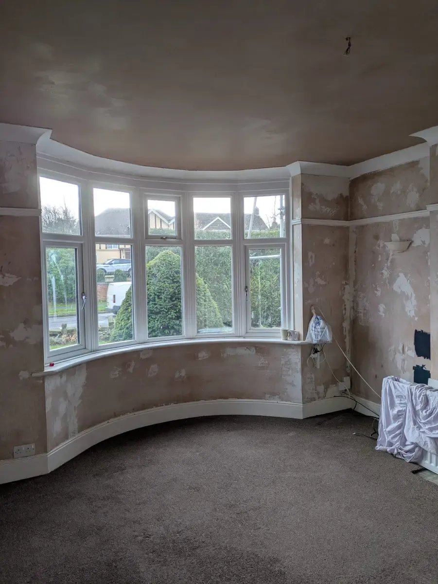 Bay-window living room stripped back and re-skimmed, ready for decorating
